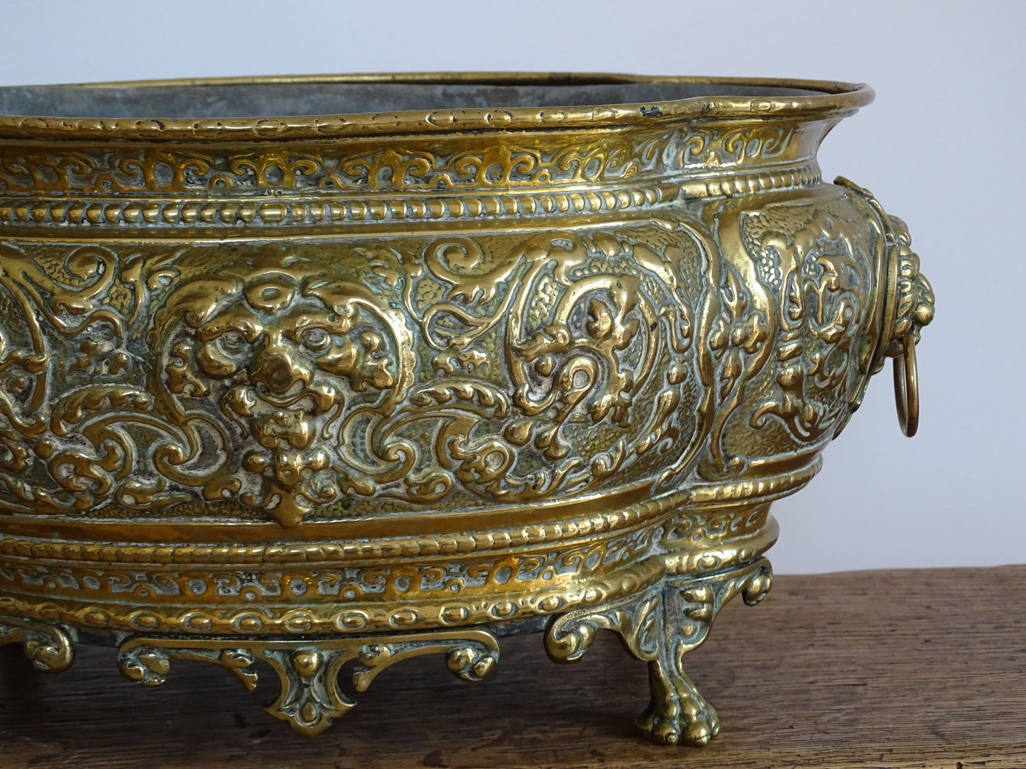 French antique brass jardinière with lion head handles and claw feet