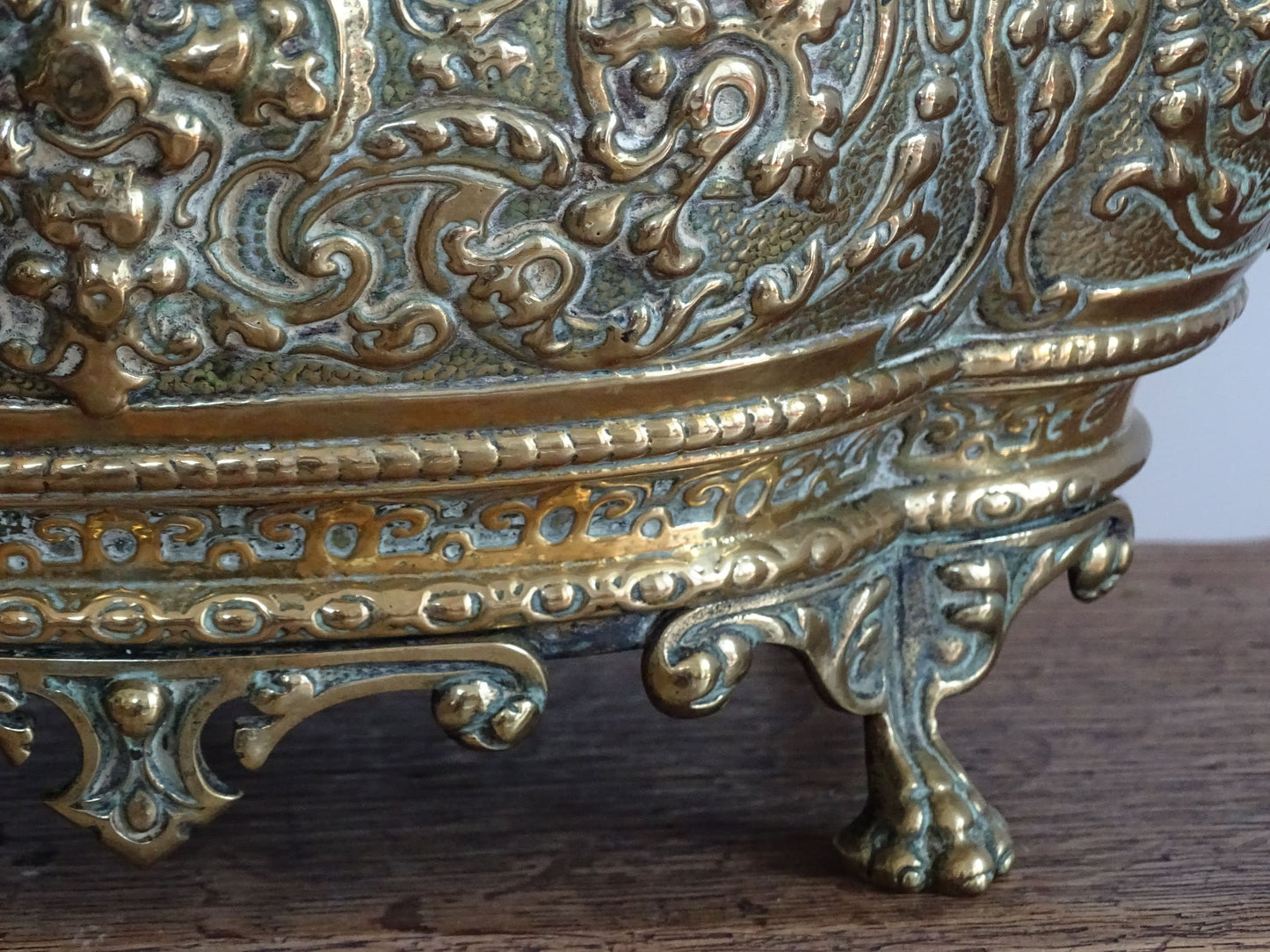 French antique brass jardinière with lion head handles and claw feet