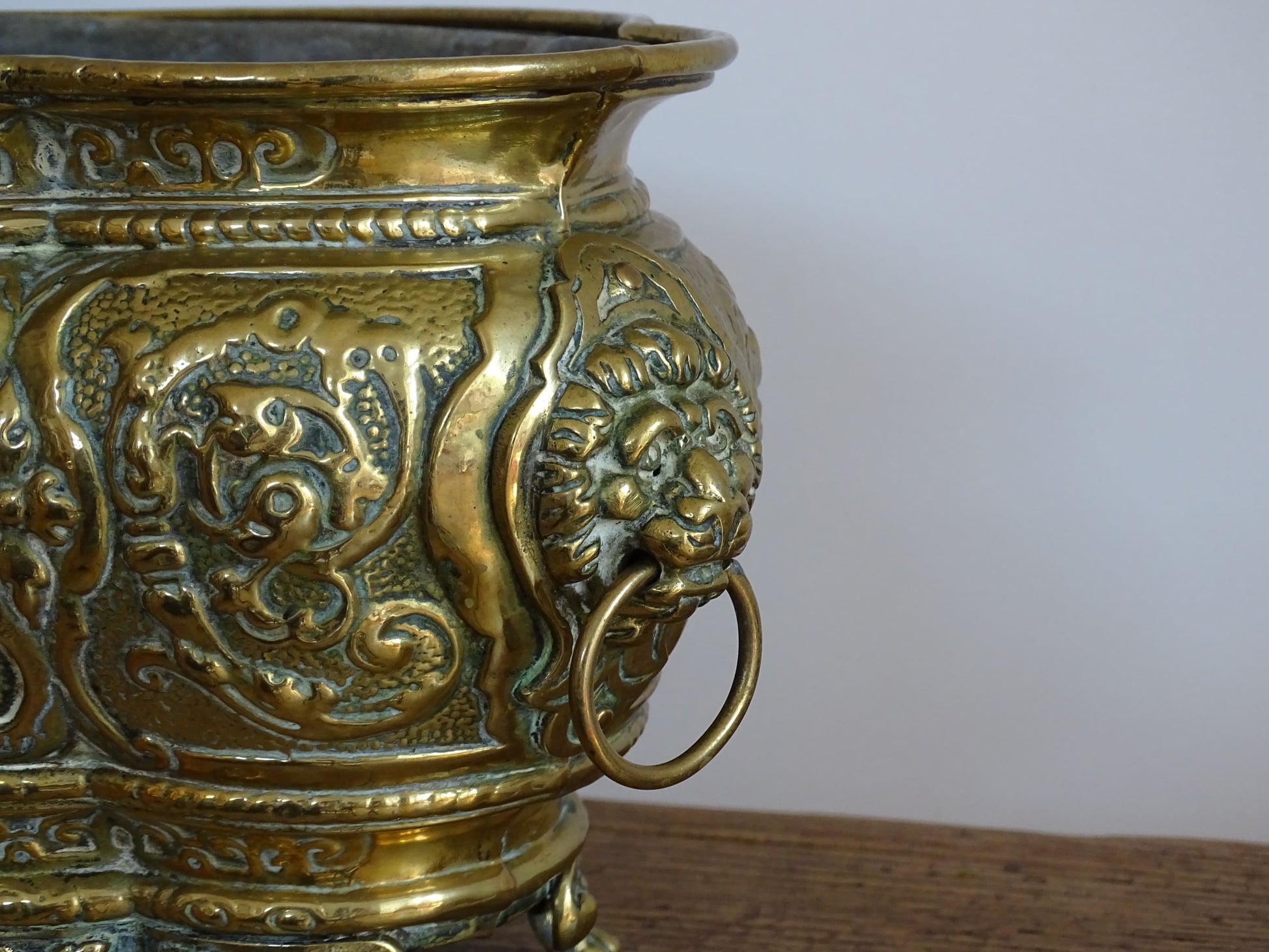 French antique brass jardinière with lion head handles and claw feet