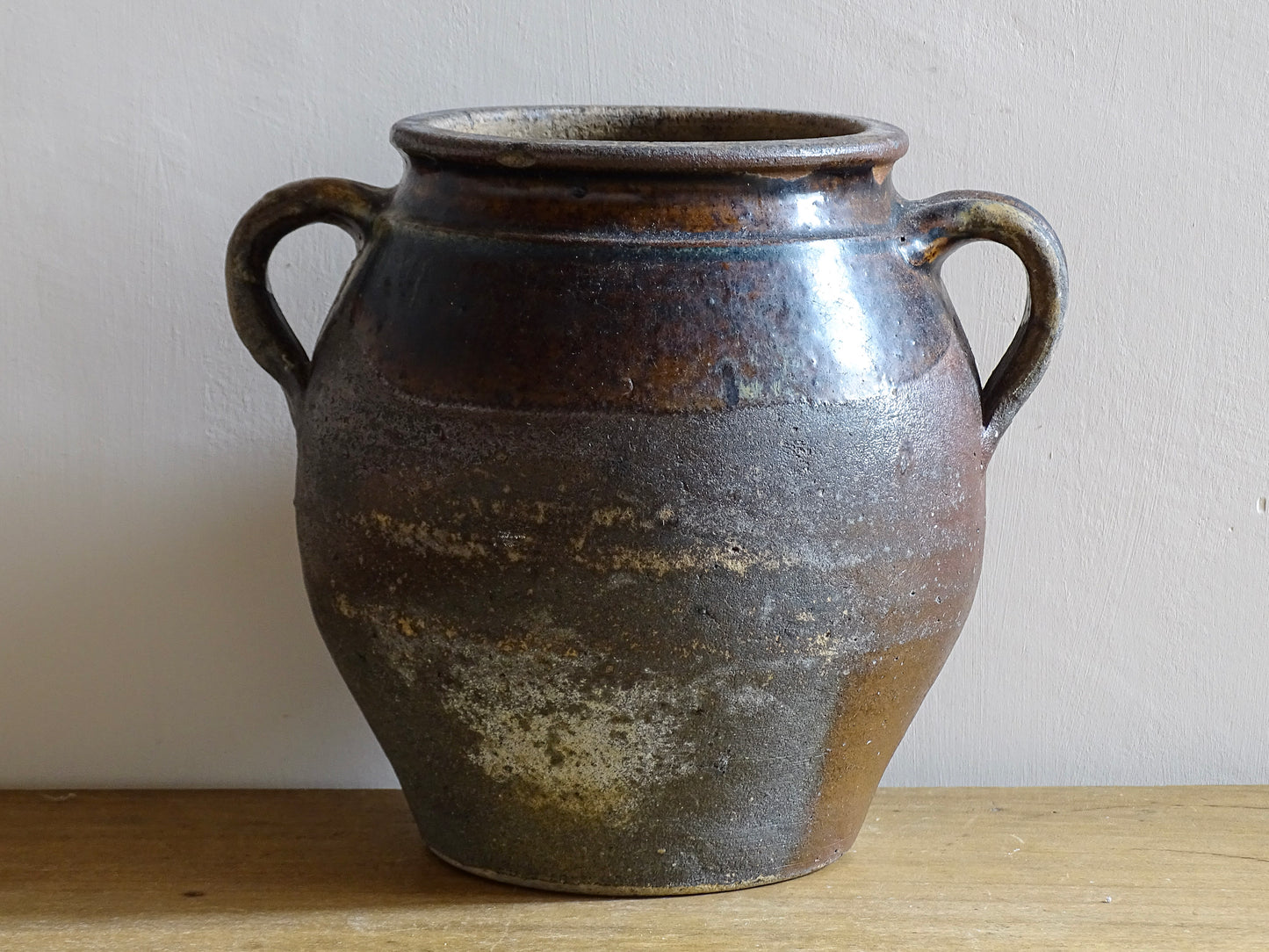 French antique earthenware vessel or confit pot in shades of brown with two handles
