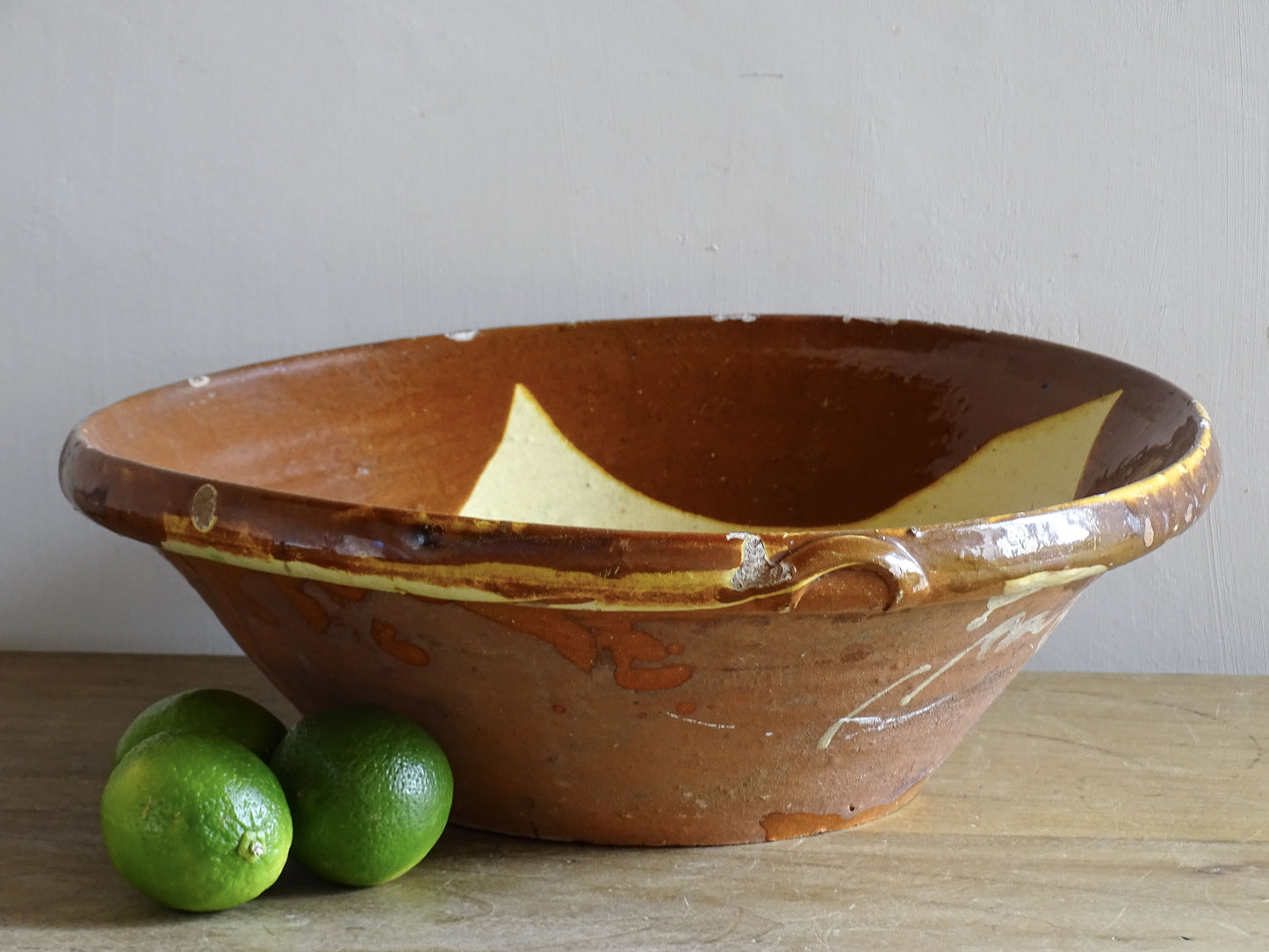 Spanish antique ceramic bowl with orange and yellow glaze
