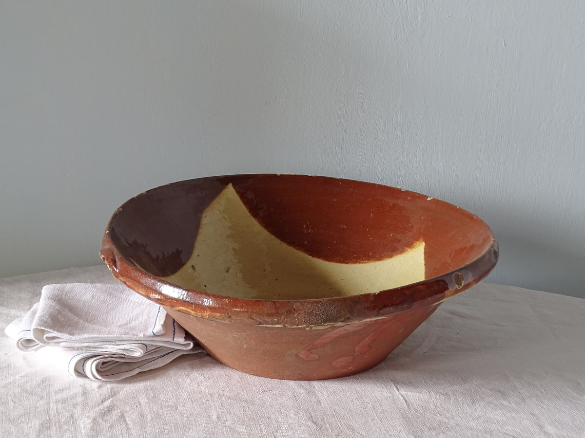 Antique earthenware bowl with red and yellow glaze