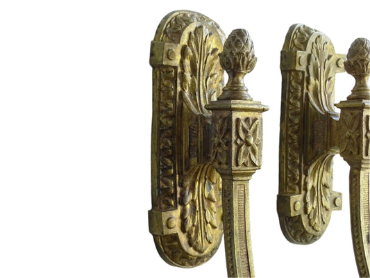 Large pair of French antique curtain hooks in gilt bronze with intricate detailing. Empire style hooks featuring intricate acanthus leaf motifs, acorn finials and architectural elements