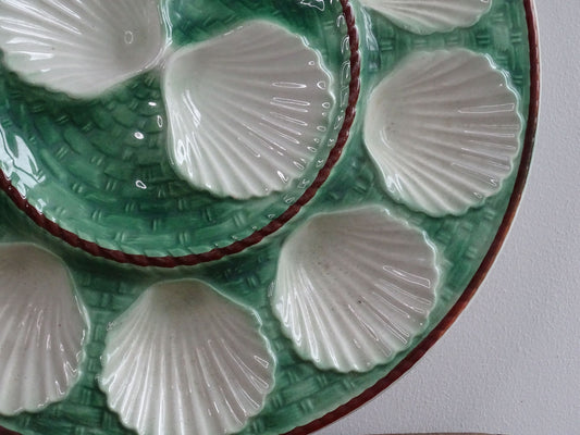 Vintage French barbotine oyster serving plate with space for twelve oysters, dating to around the 1930s. It has a green, basketweave design with a brown edge