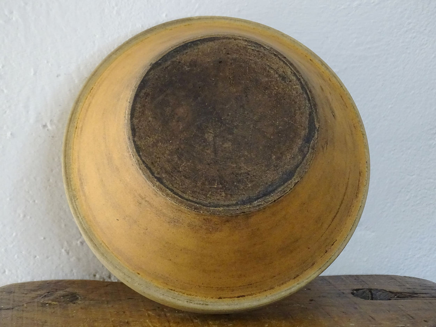 Rustic French antique ceramic mixing bowl with an orange glaze to the interior. Terracotta pottery bowl for a French country farmhouse kitchen.