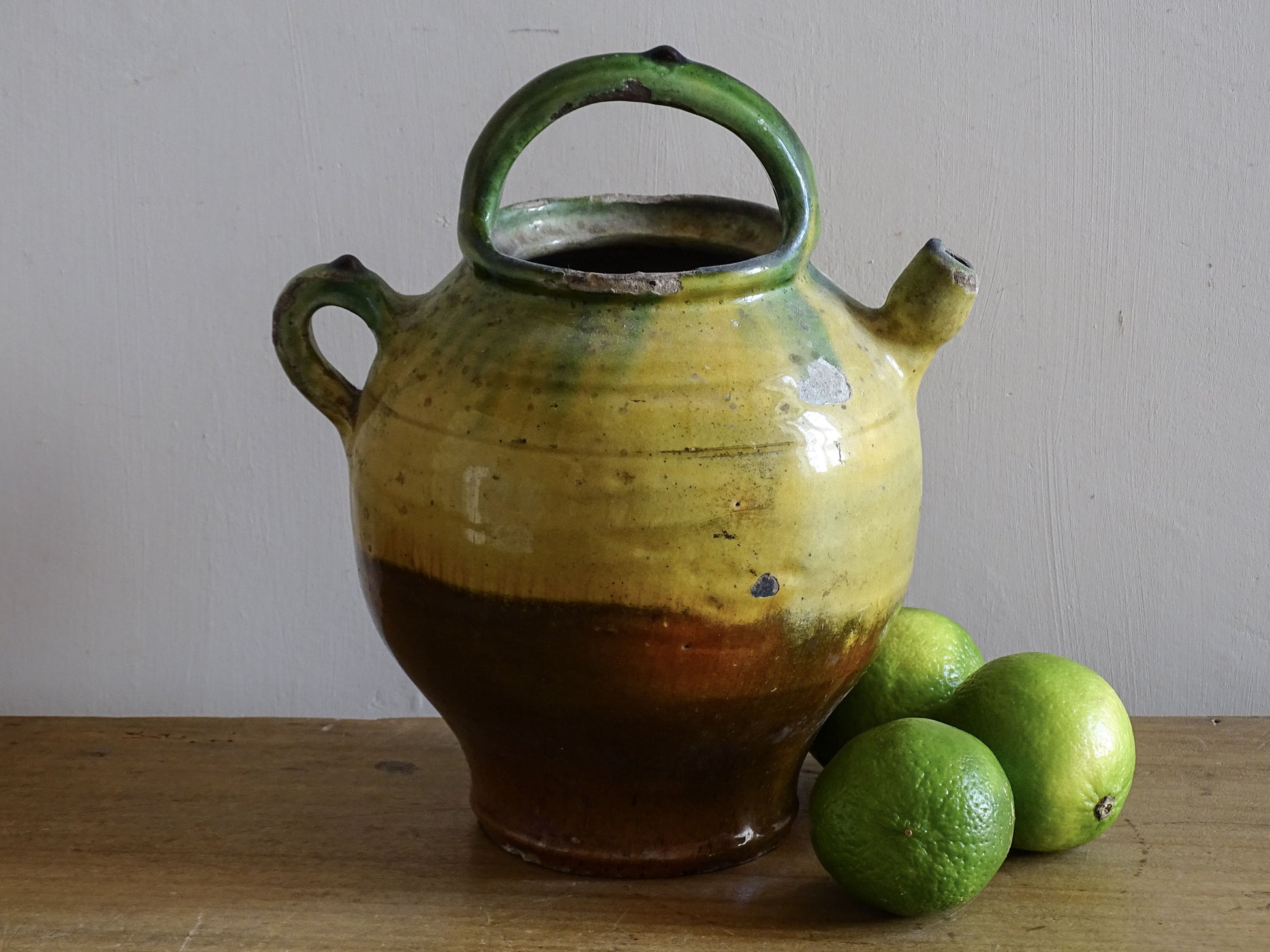 French antique pottery pitcher or gargoulette with a yellow and green glaze 