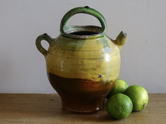 French antique pottery pitcher or gargoulette with a yellow and green glaze 