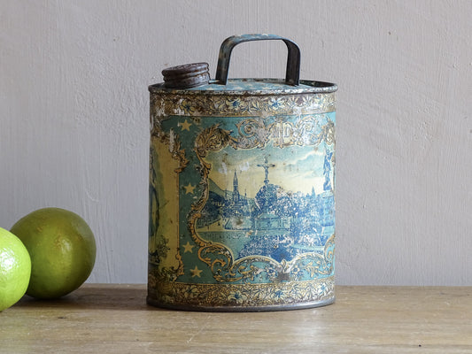 French antique Lourdes souvenir water flask in light blue, made from pewter, the top is decorated with stars, one side shows a view towards the cathedral (Sanctuaire de Notre-Dame de Lourdes), the other shows pilgrims in early 20th century dress attending mass at the Grotto of Massabielle. To the side is a depiction of the Virgin Mary. Flask for Lourdes holy water. Antique Lourdes souvenir religious decor.
