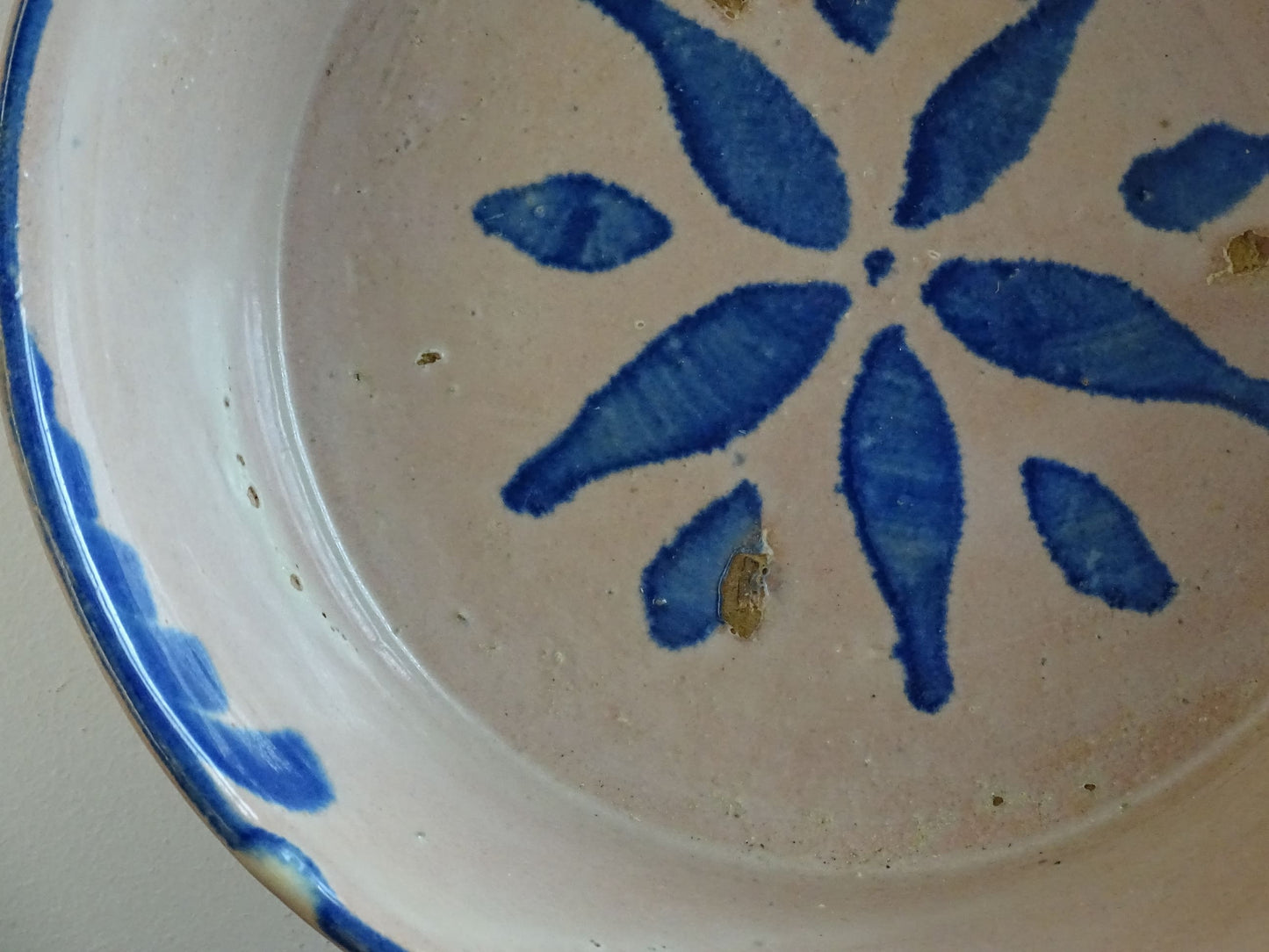 Spanish antique Fajalauza ceramic lebrillo from Granada. Terracotta ottery bowl with a pink tone and hand-painted blue star-shaped flower. Deep bowl for antique wall. Antique Mediterranean decor, decorative bowl. 