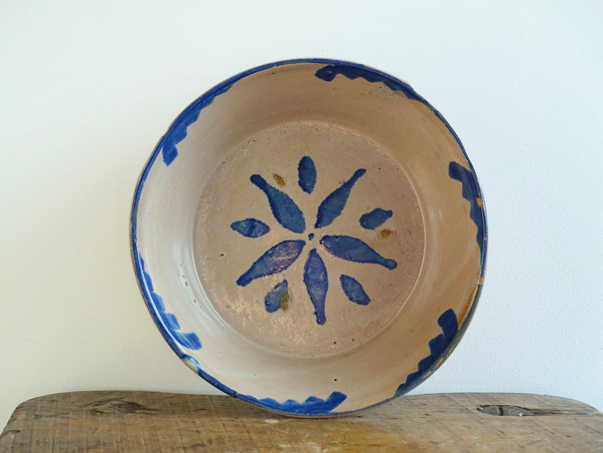 Spanish antique Fajalauza ceramic lebrillo from Granada. Terracotta ottery bowl with a pink tone and hand-painted blue star-shaped flower. Deep bowl for antique wall. Antique Mediterranean decor, decorative bowl. 