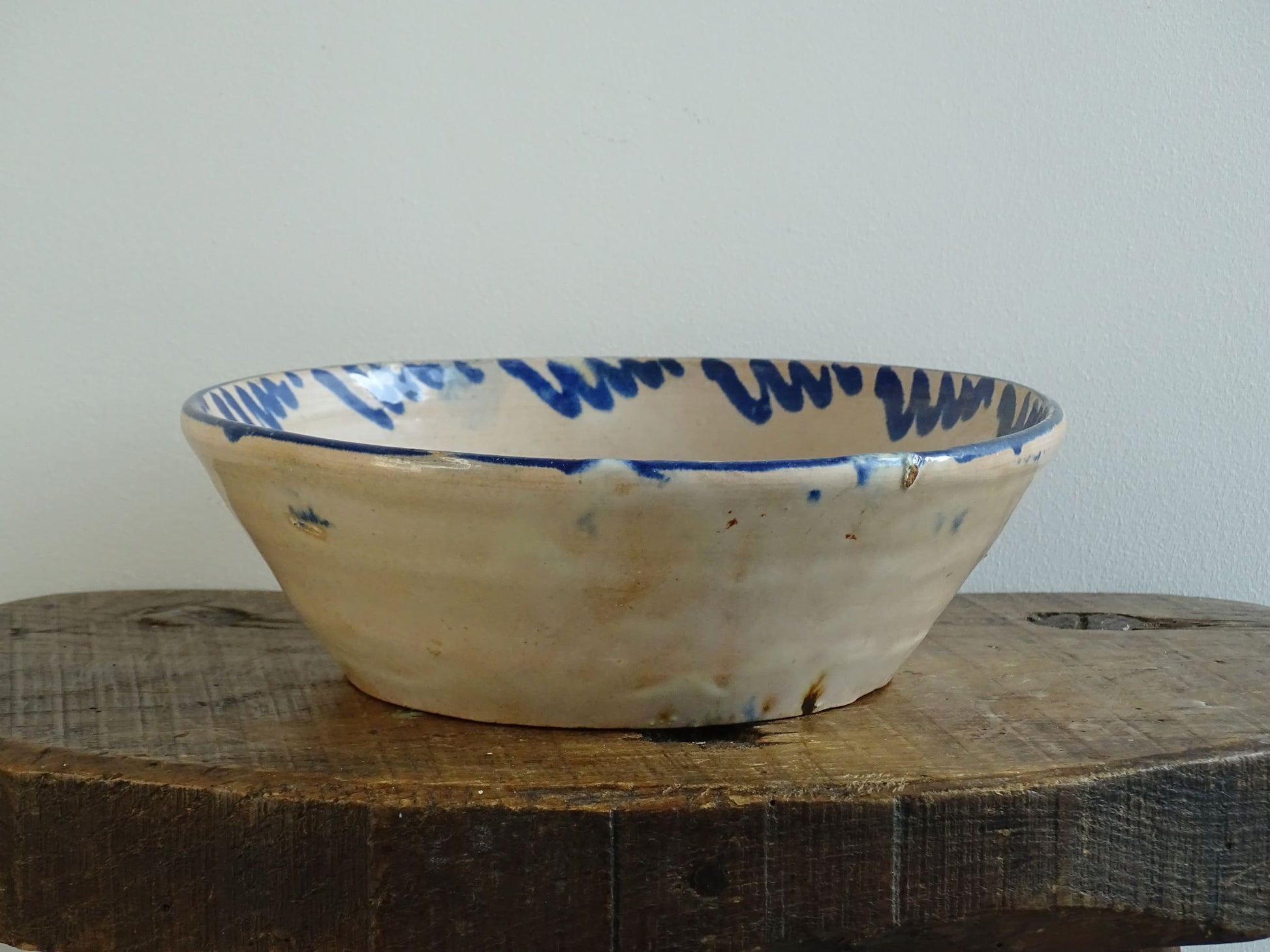 Spanish antique Fajalauza pottery lebrillo from Granada. Tin glazed terracotta bowl, hand-painted with blue leaves and flowers.