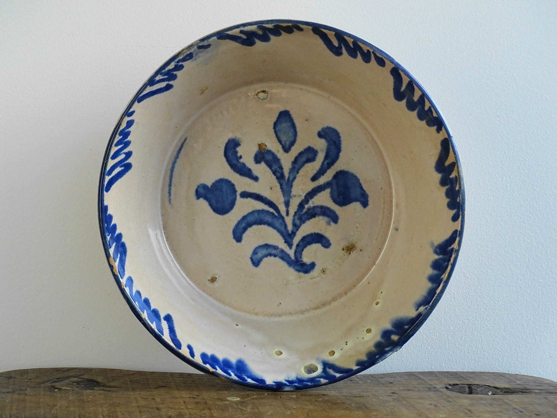 Spanish antique Fajalauza pottery lebrillo from Granada. Tin glazed terracotta bowl, hand-painted with blue leaves and flowers.