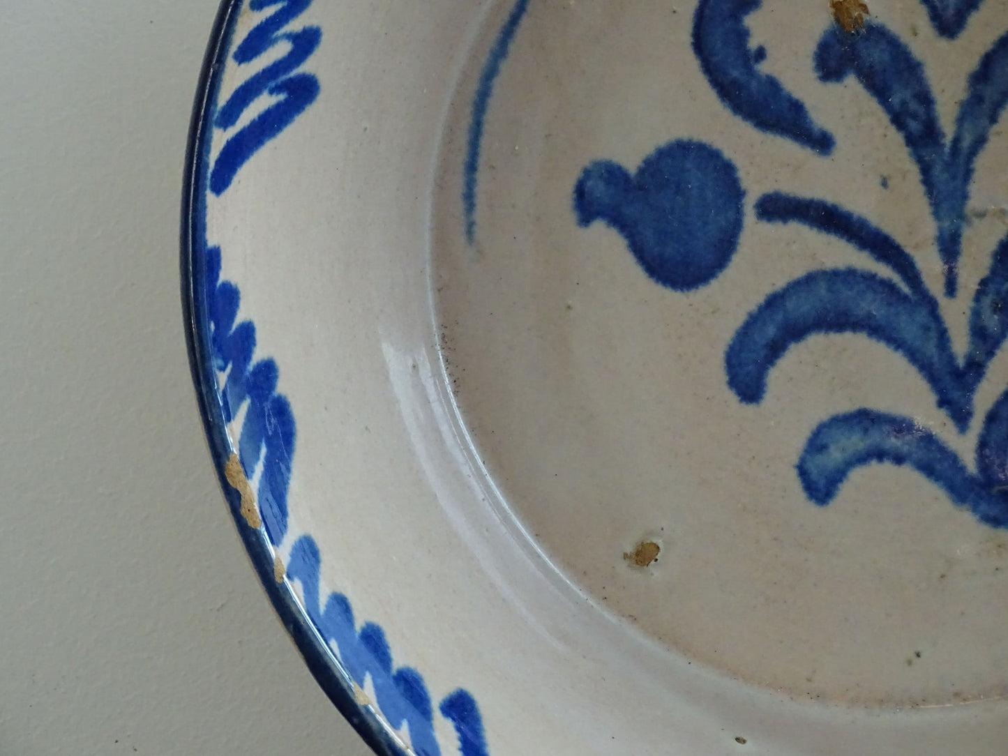 Spanish antique Fajalauza pottery lebrillo from Granada. Tin glazed terracotta bowl, hand-painted with blue leaves and flowers.