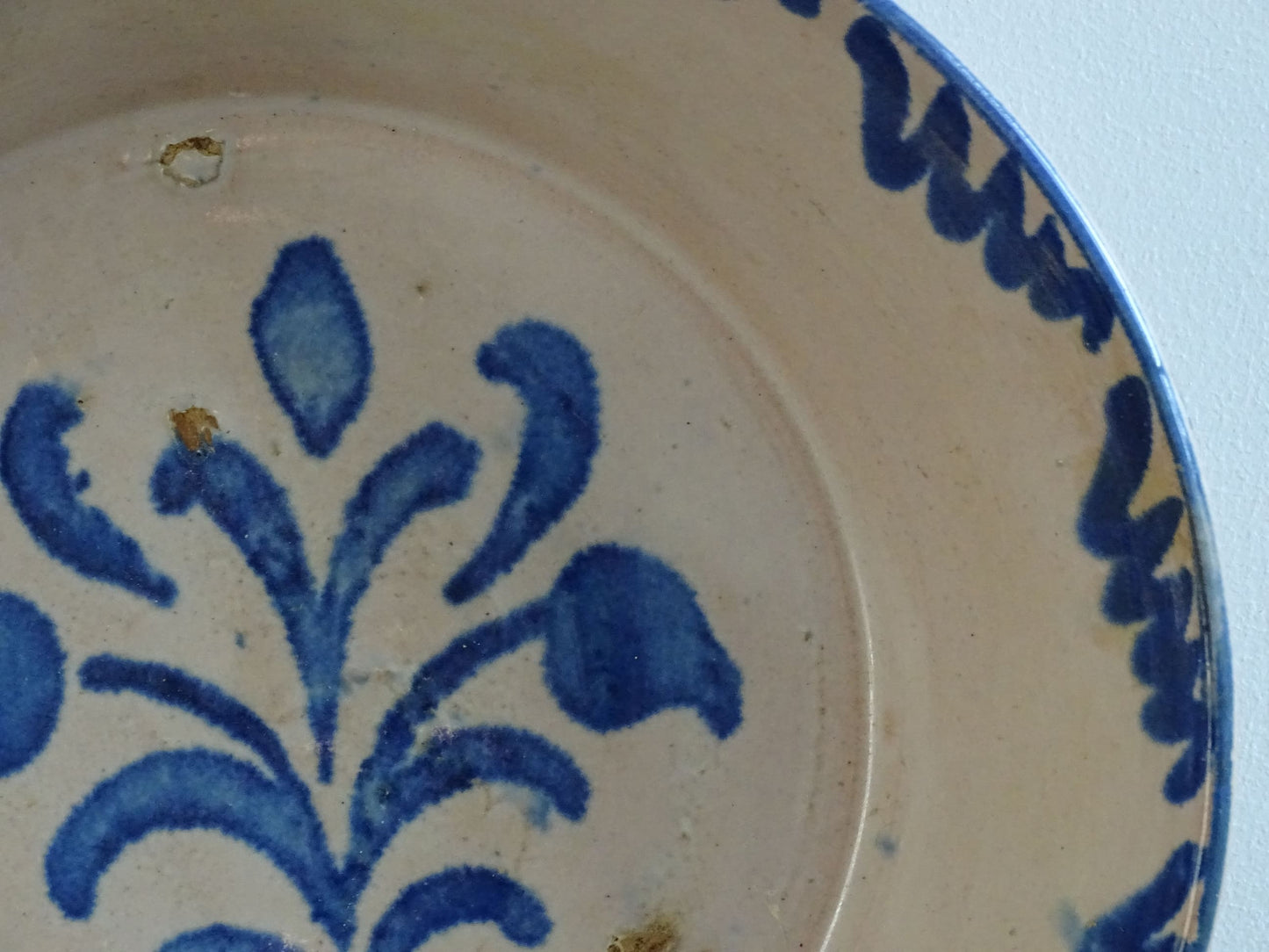 Spanish antique Fajalauza pottery lebrillo from Granada. Tin glazed terracotta bowl, hand-painted with blue leaves and flowers.