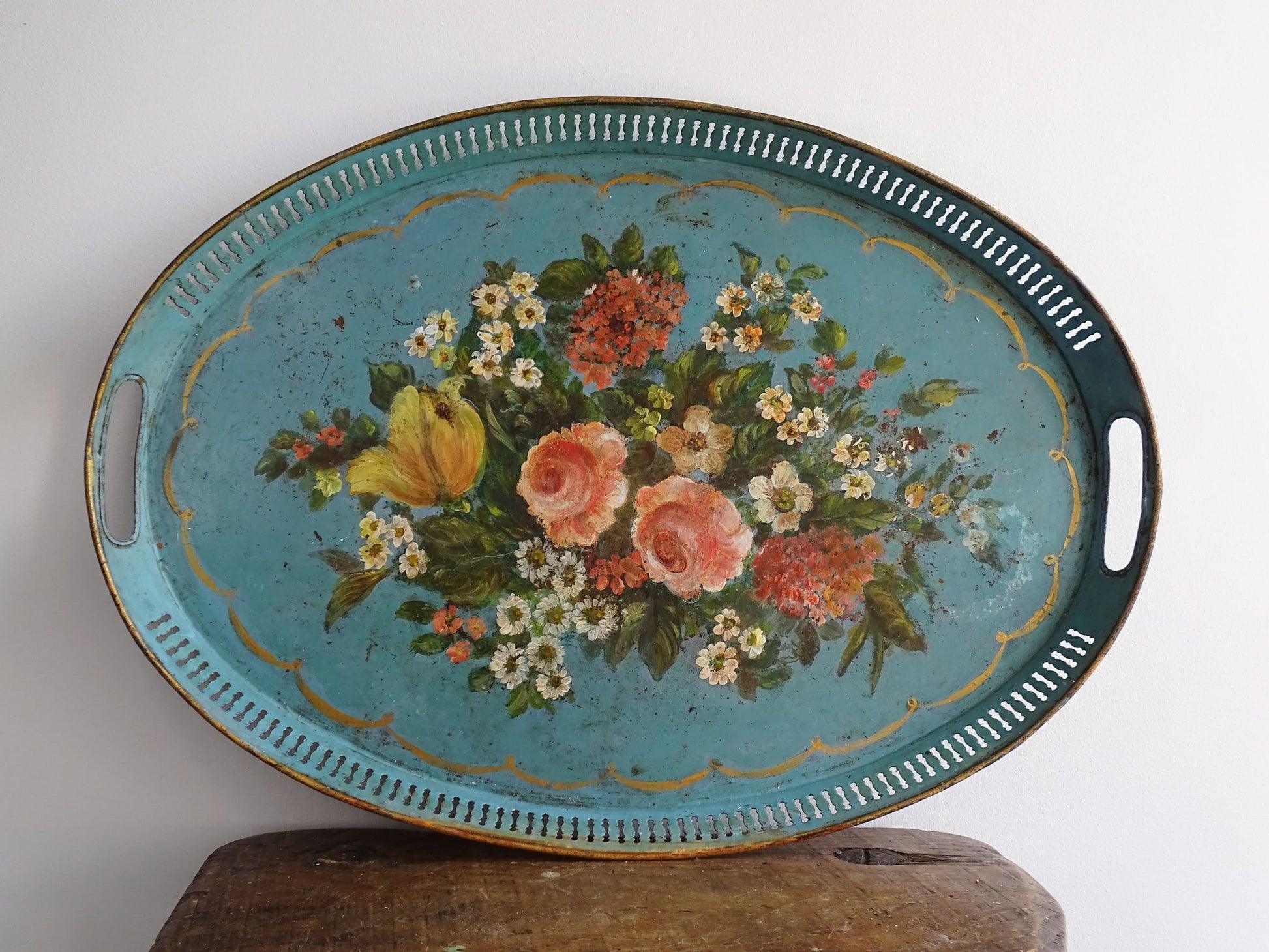 French antique toleware tray in a bright blue and hand-painted with flowers and foliage, surrounded by a gold border. Oval in shape with gallery edge. Blue toleware.