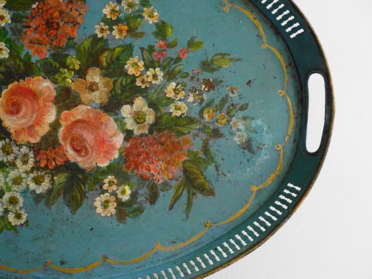 French antique toleware tray in a bright blue and hand-painted with flowers and foliage, surrounded by a gold border. Oval in shape with gallery edge. Blue toleware.