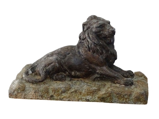 French antique lion ornament in cast metal with a dark, aged patina. Resting on a textured base, the lion's detailed mane is very nicely detailed and can serve as a paperweight or decorative accent.