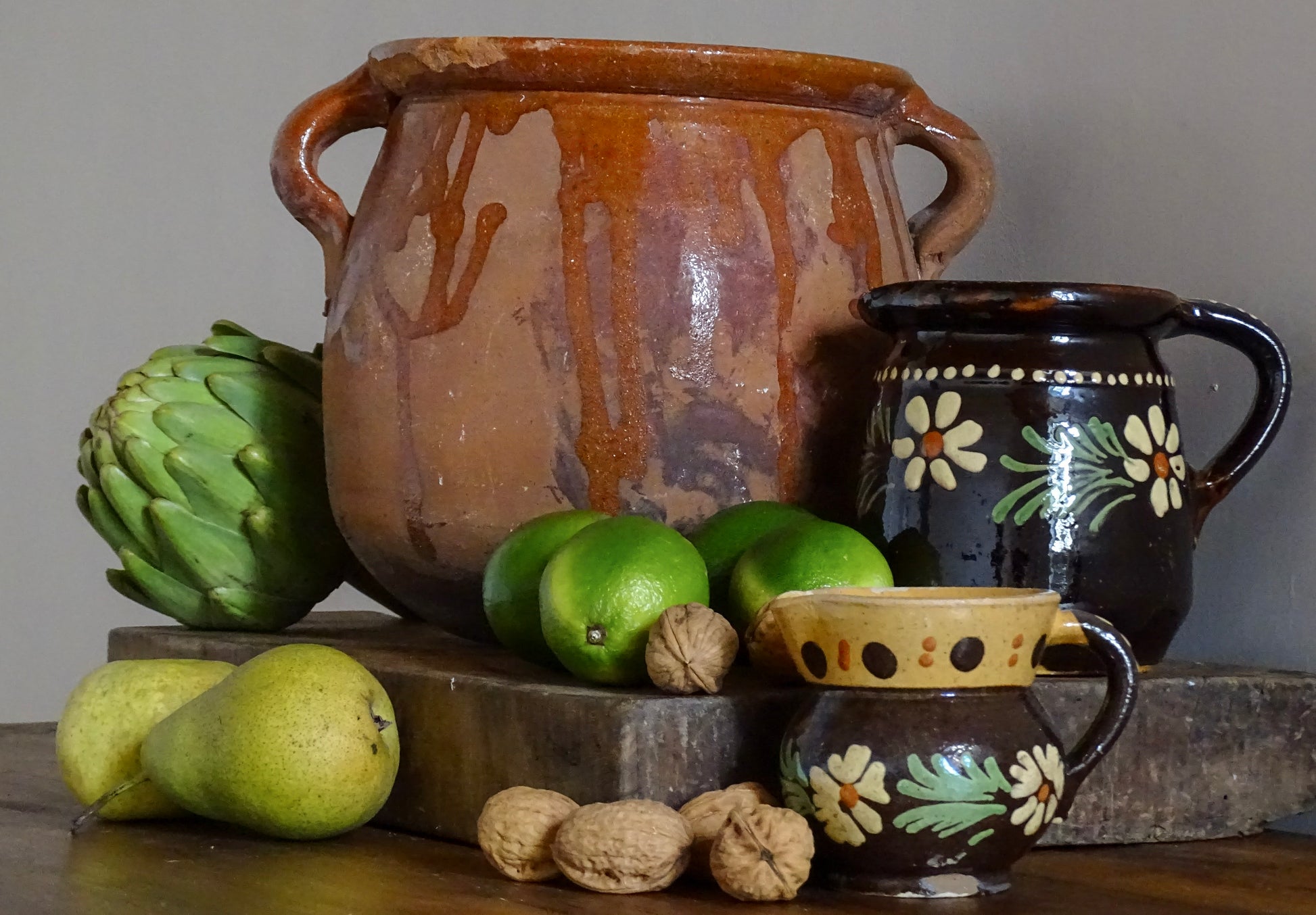French antique pottery collection including a vintage terracotta pot with an orange drip glaze and two ceramic jugs from Alsace with hand-painted flowers