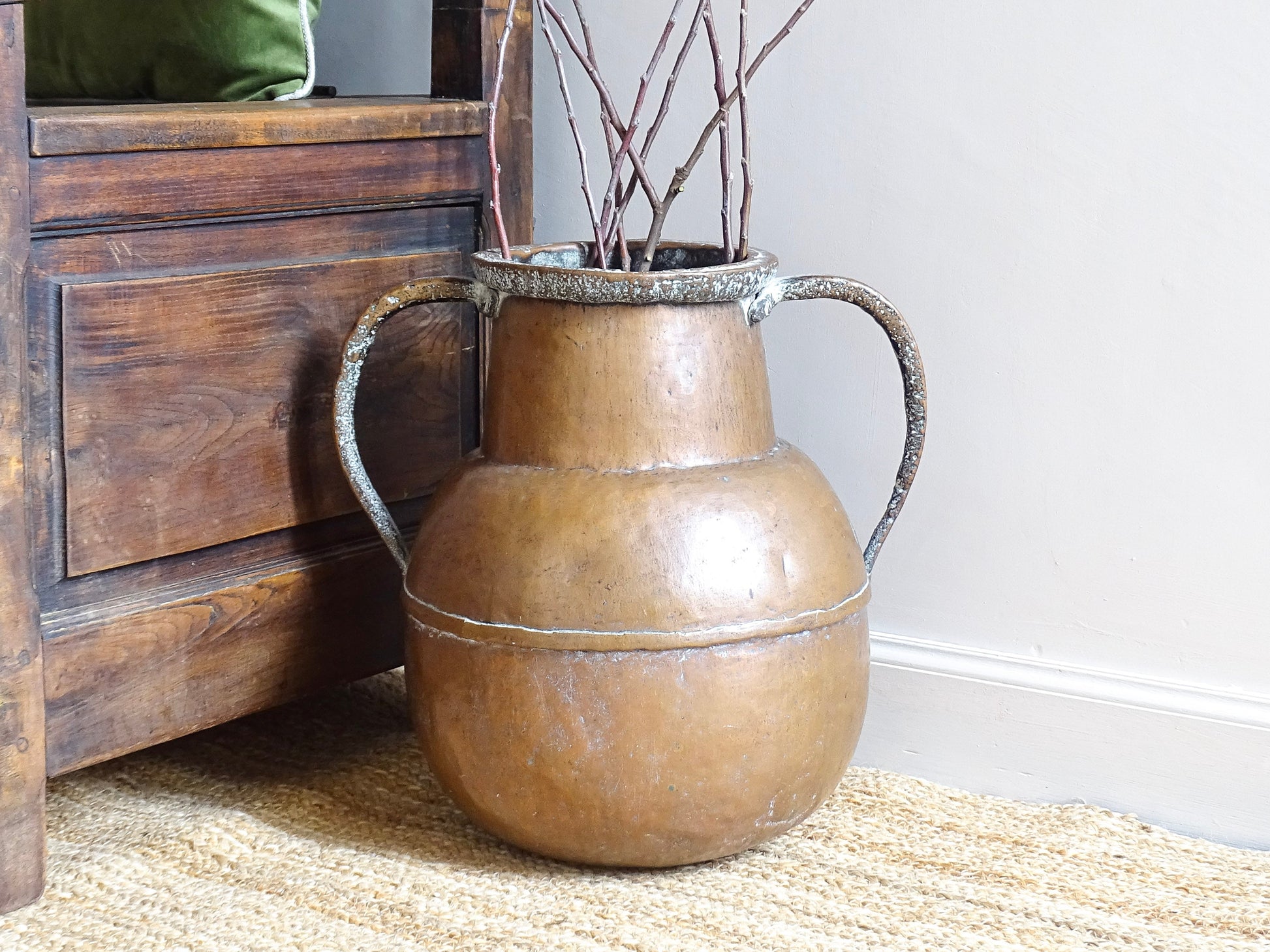 A large 18th-century antique copper water pot from Normandy with a rounded form and double handles, showcasing a warm aged patina