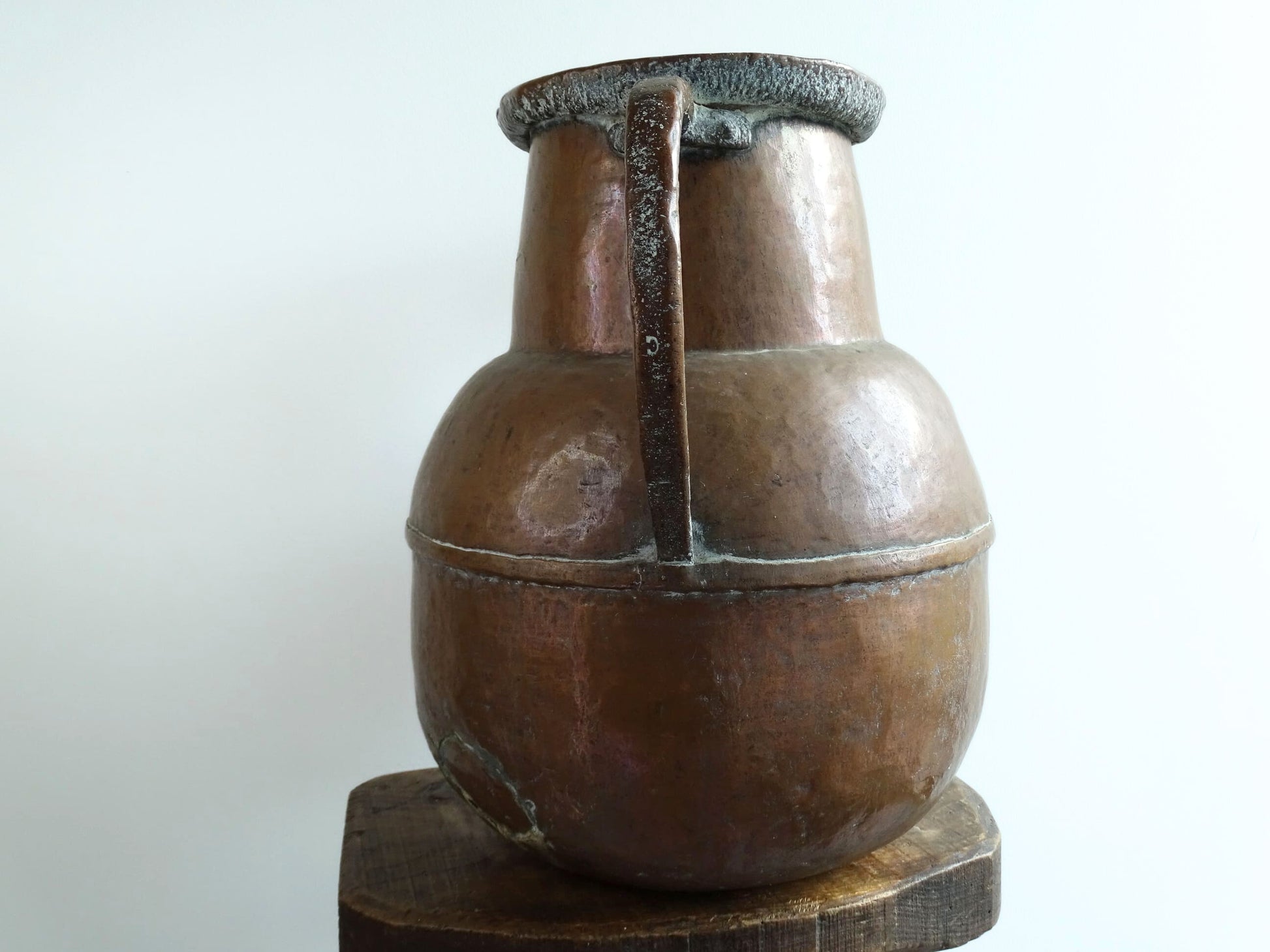 A large 18th-century antique copper water pot from Normandy with a rounded form and double handles, showcasing a warm aged patina