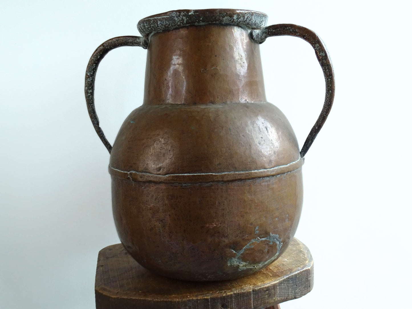 A large 18th-century antique copper water pot from Normandy with a rounded form and double handles, showcasing a warm aged patina