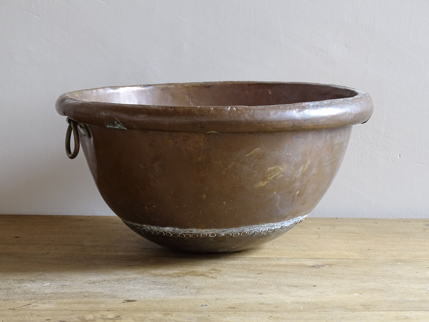 French Antique Copper Bowl for Confectioners 18th C. This timeworn copper mixing bowl has a rolled top and copper rivets to the curved base. 