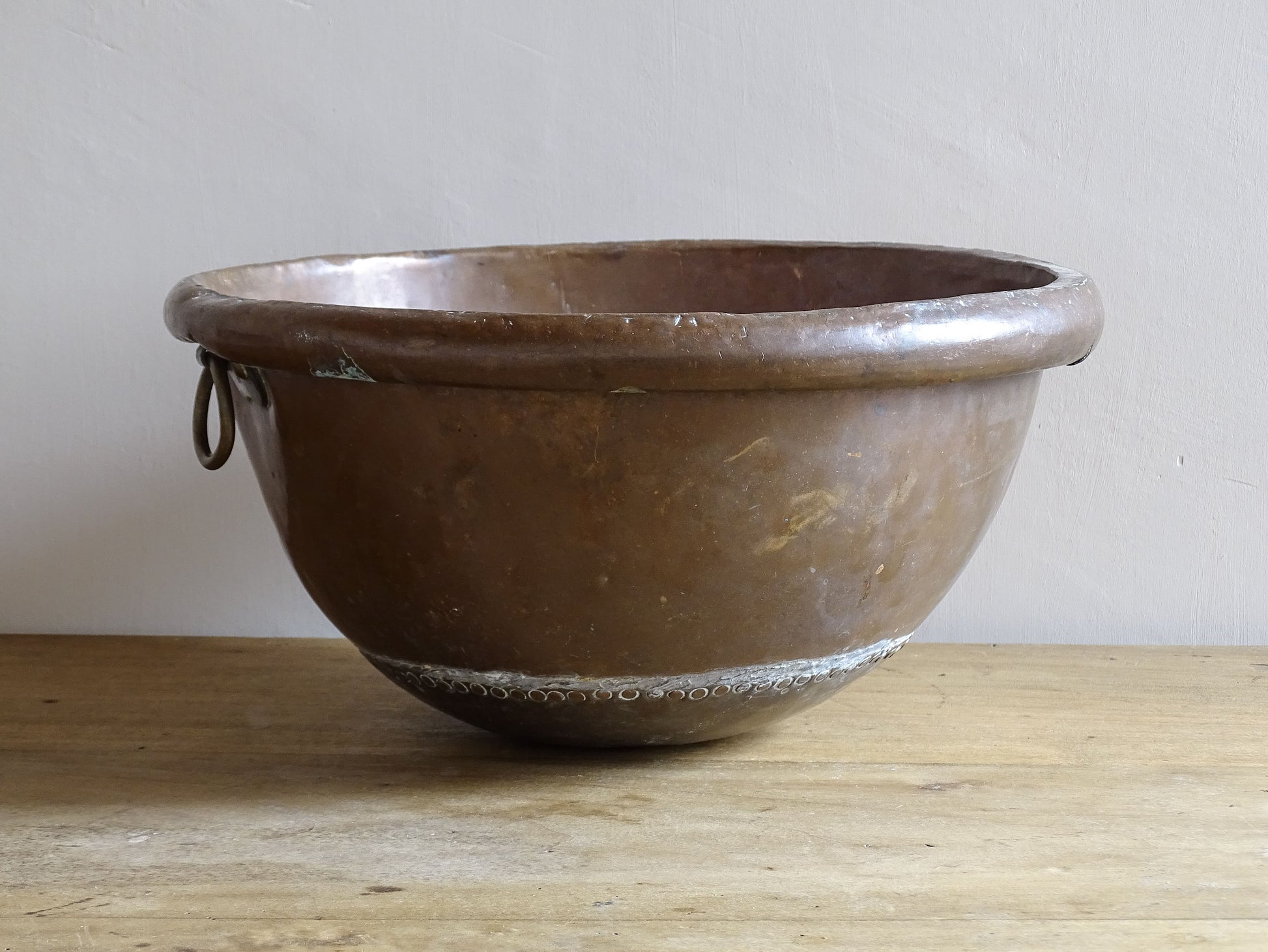 French Antique Copper Bowl for Confectioners 18th C. This timeworn copper mixing bowl has a rolled top and copper rivets to the curved base. 