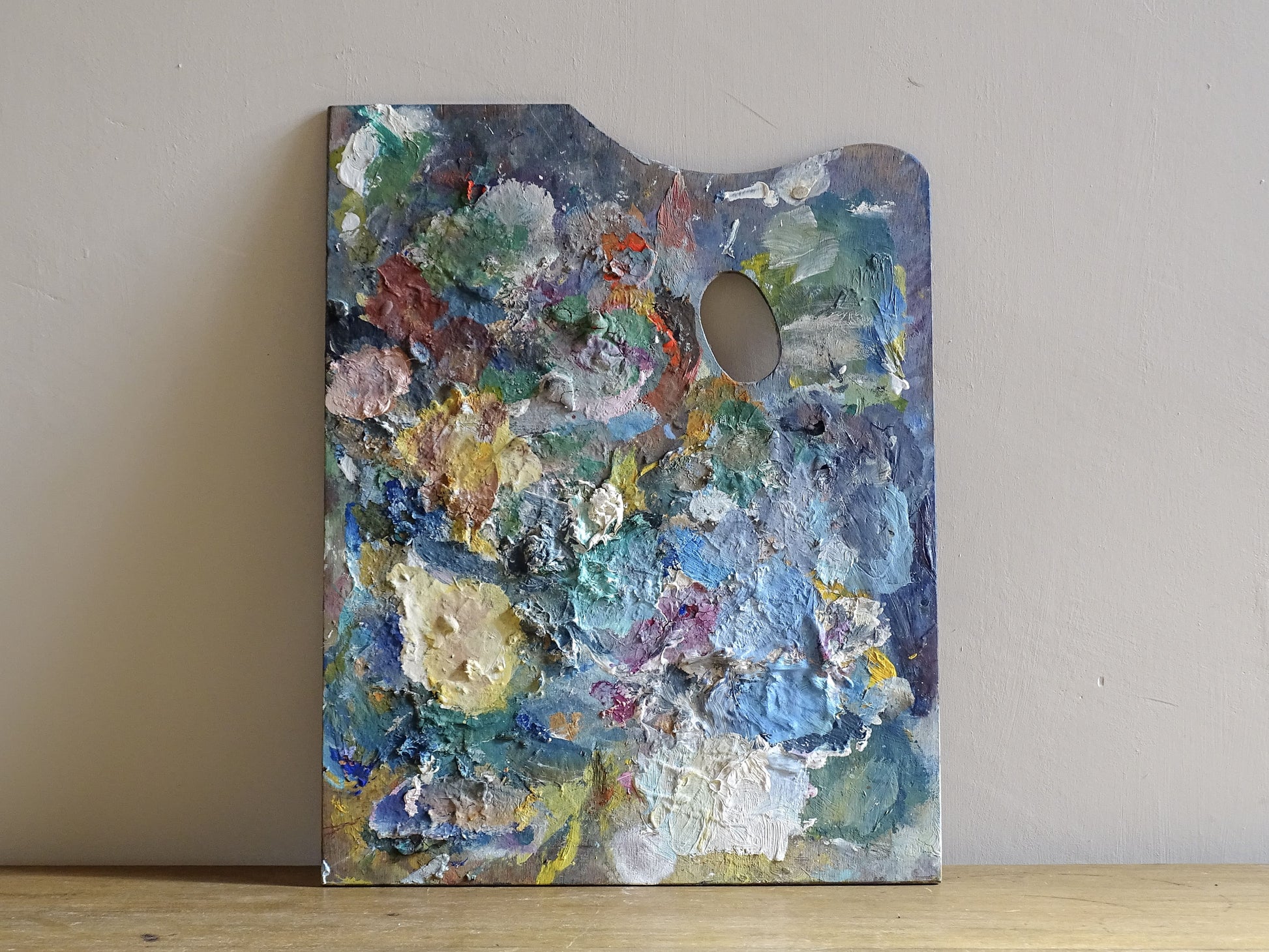 French vintage wooden paint palette with layers of paint for art studio decor