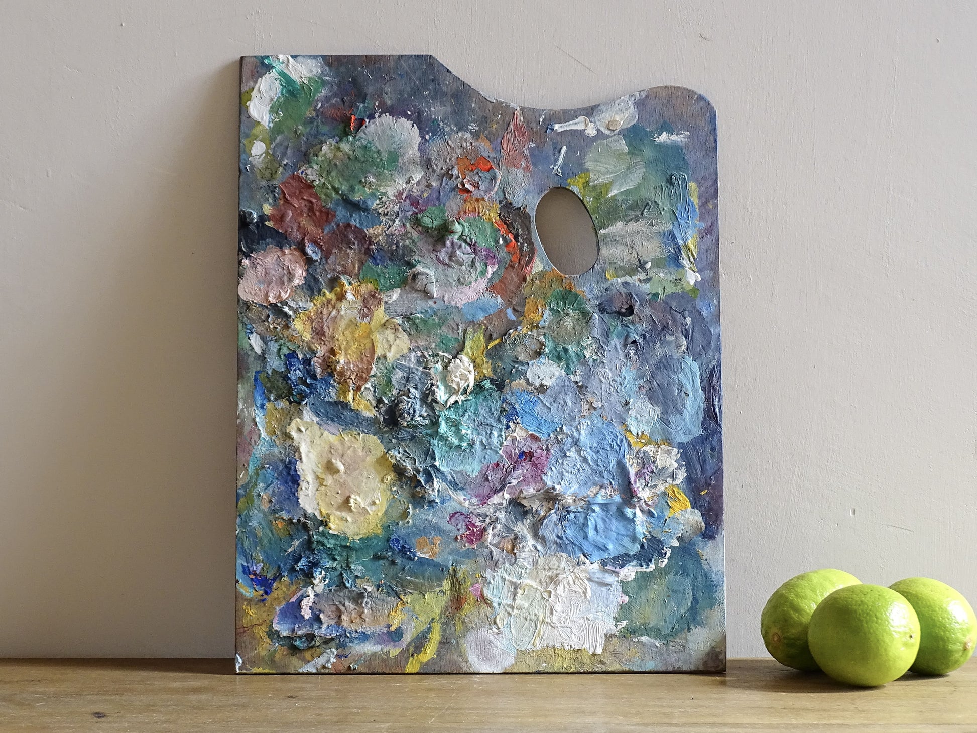 French vintage wooden paint palette with layers of paint for art studio decor