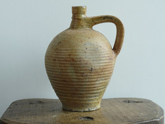 Rustic French antique pottery pitcher with orange and natural tones. Antique pitcher with rich texture for a rustic farmhouse kitchen. 