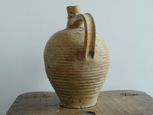 Rustic French antique pottery pitcher with orange and natural tones. Antique pitcher with rich texture for a rustic farmhouse kitchen. 