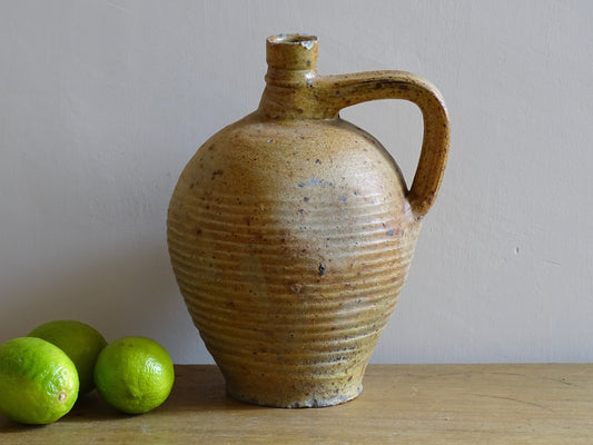 Rustic French antique pottery pitcher with orange and natural tones. Antique pitcher with rich texture for a rustic farmhouse kitchen. 