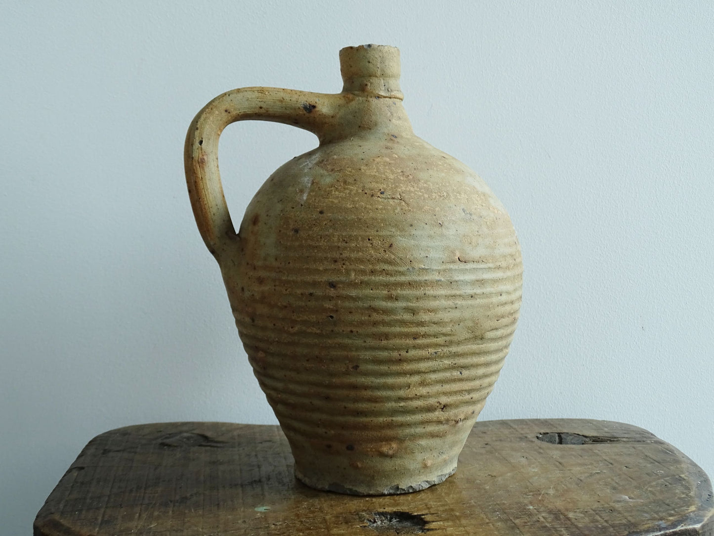 Rustic French antique pottery pitcher with orange and natural tones. Antique pitcher with rich texture for a rustic farmhouse kitchen. 