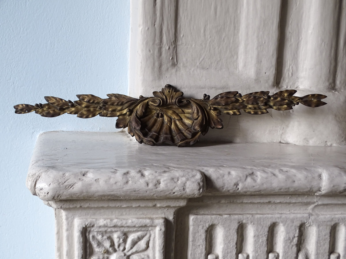 French antique gilt bronze furniture pediment, displayed on a country house fireplace mantel