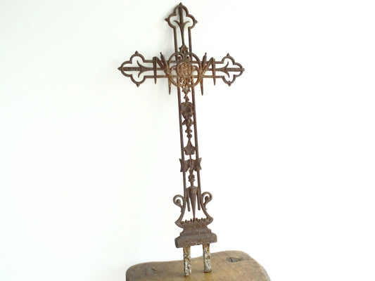 French antique cast iron field cross. Aged and rusted antique pilgrim cross decorated with grapes and vines.