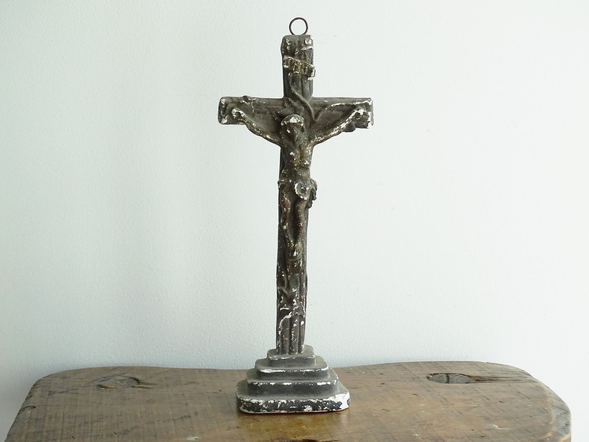 Timeworn French antique altar cross in plaster with a hook on the top so it. Antique altar crucifix as religious decor.