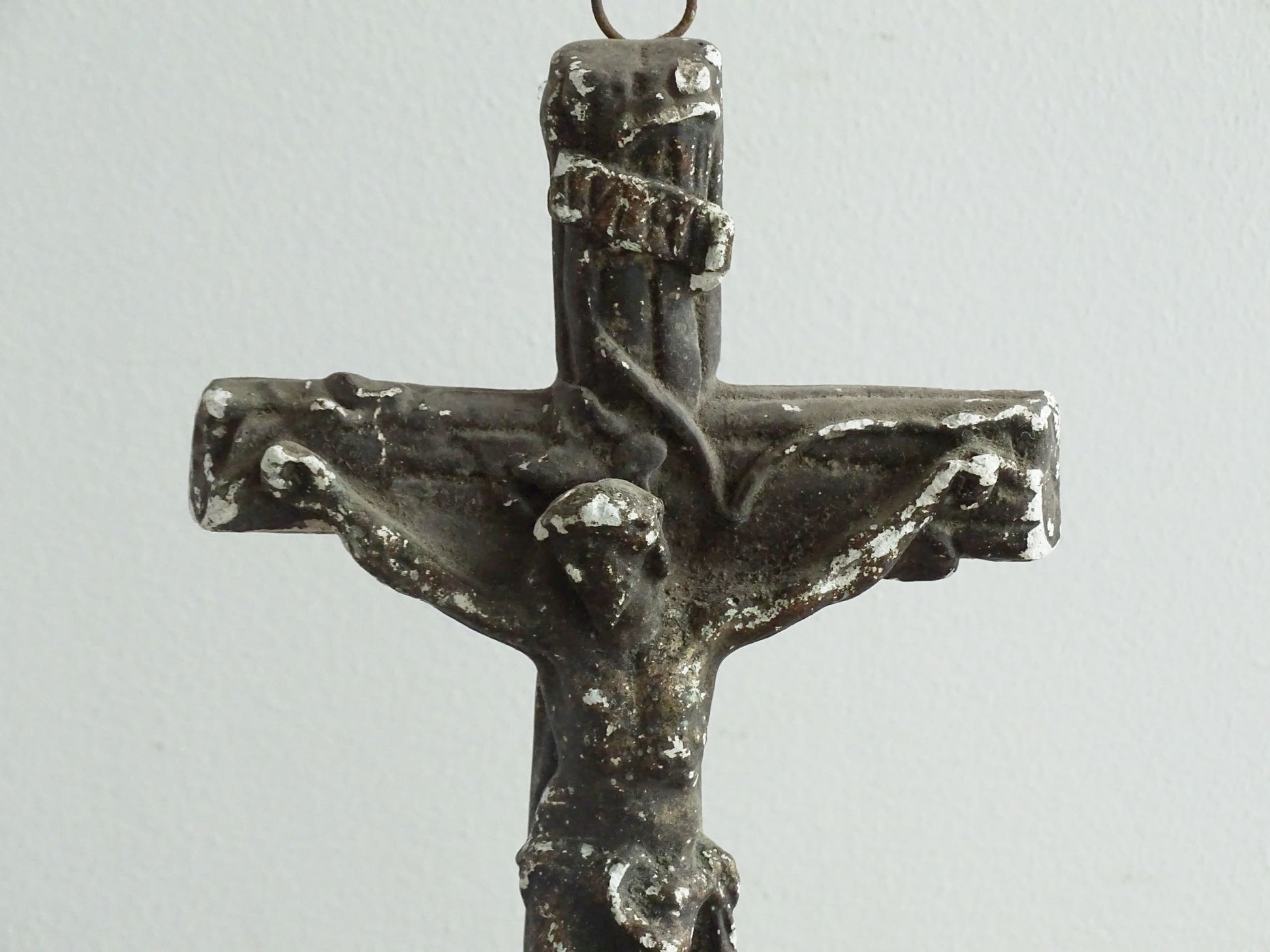 Timeworn French antique altar cross in plaster with a hook on the top so it. Antique altar crucifix as religious decor.