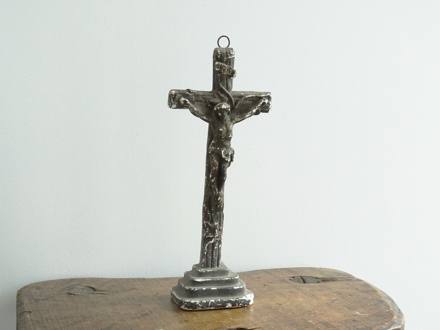 Timeworn French antique altar cross in plaster with a hook on the top so it. Antique altar crucifix as religious decor.