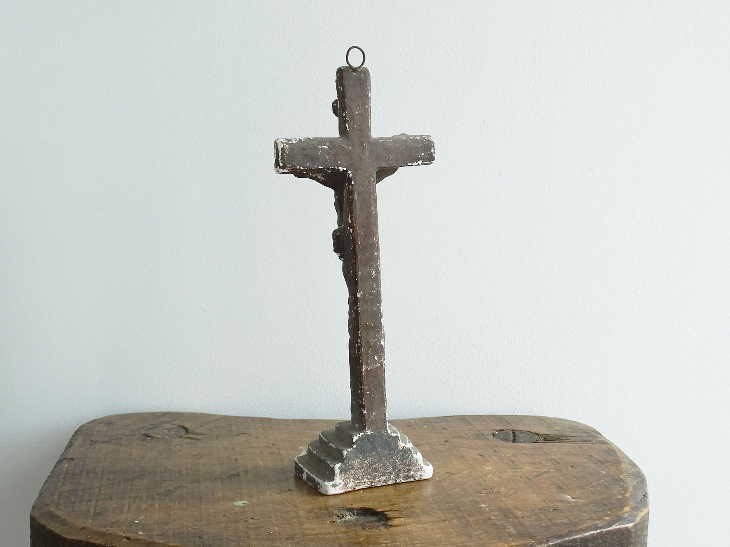 Timeworn French antique altar cross in plaster with a hook on the top so it. Antique altar crucifix as religious decor.