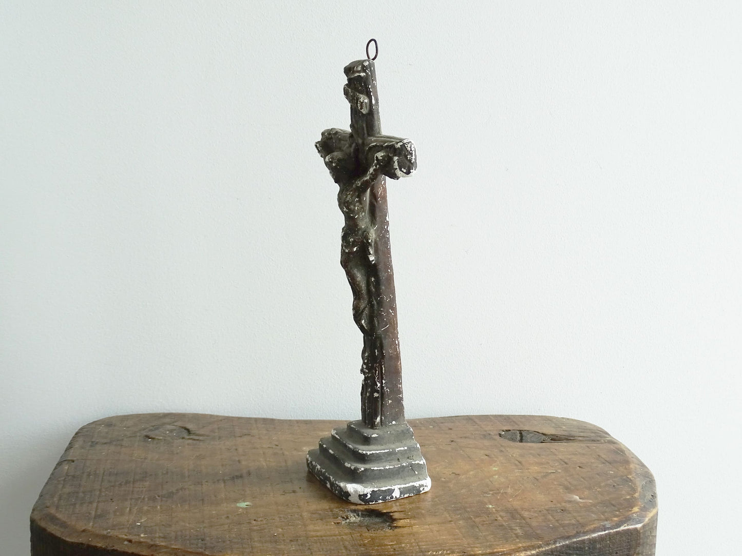 Timeworn French antique altar cross in plaster with a hook on the top so it. Antique altar crucifix as religious decor.