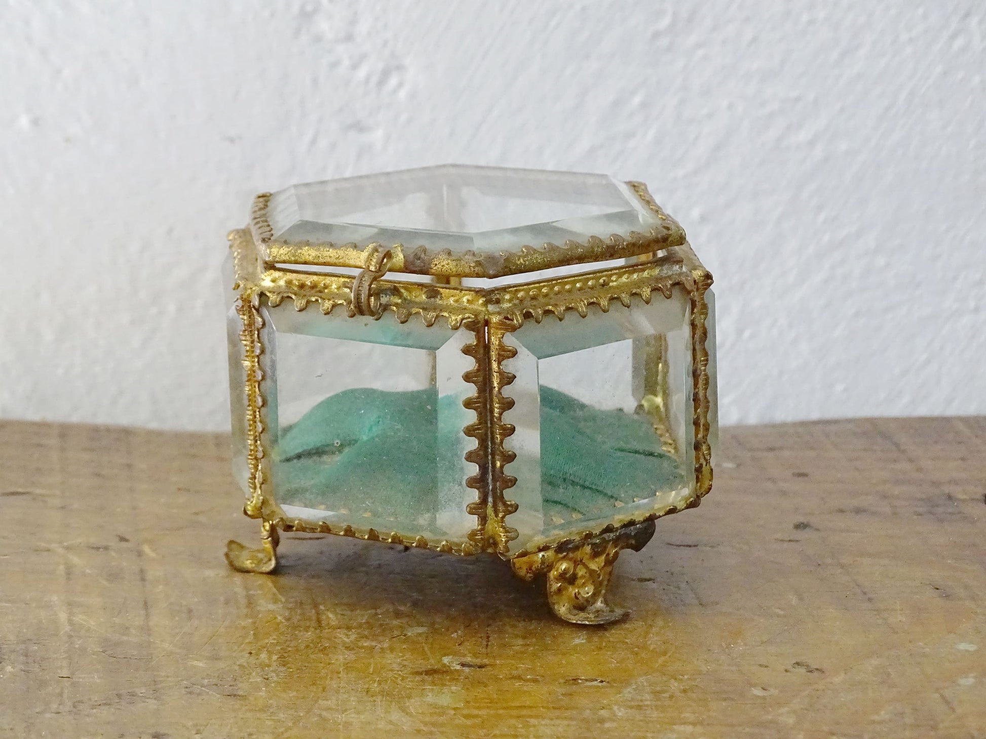 French antique glass jewelry box with bevelled glass, green silk cushion and gilt detailing