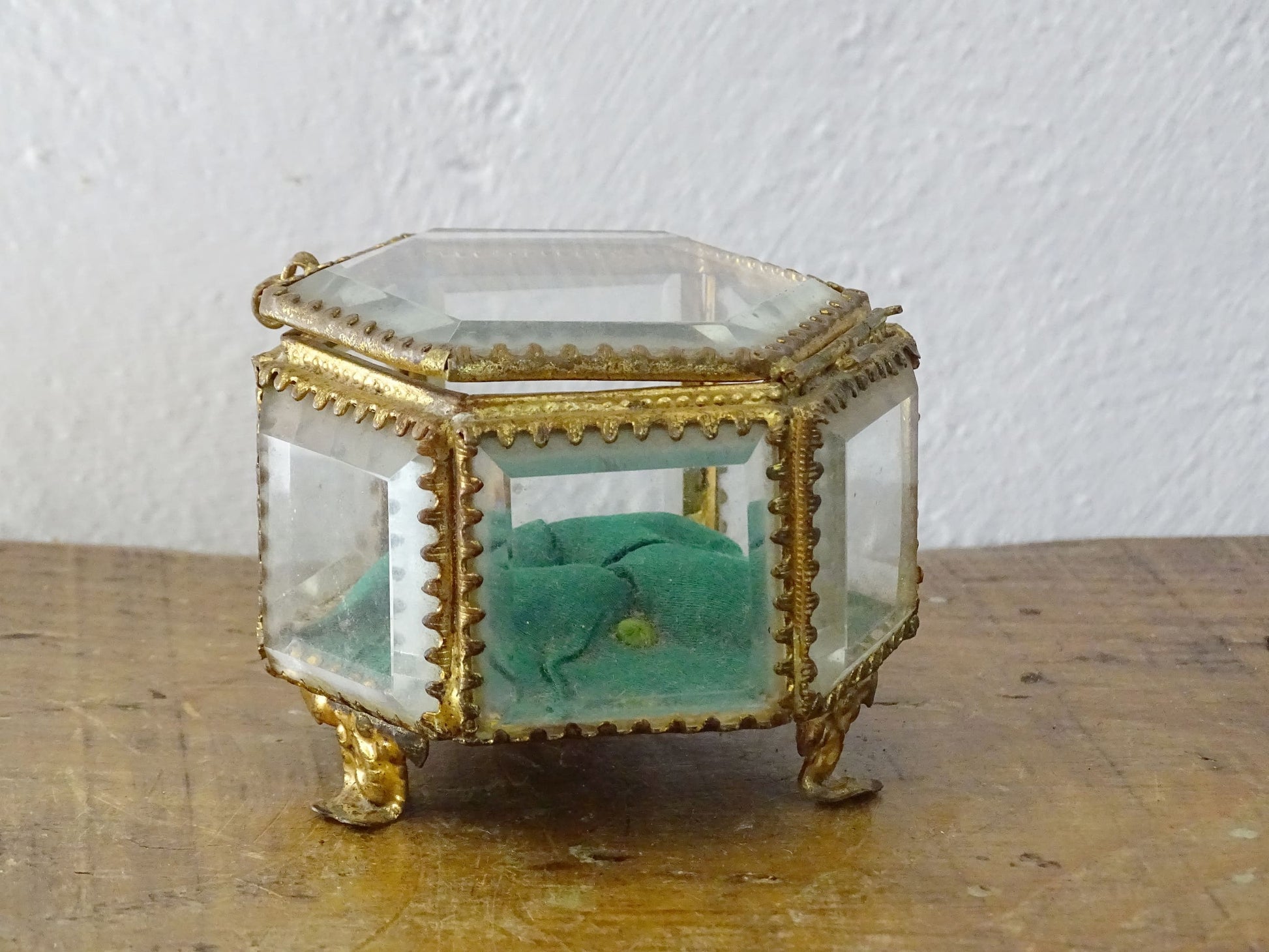 French antique glass jewelry box with bevelled glass, green silk cushion and gilt detailing