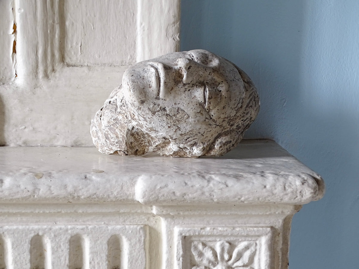 French antique plaster head sculpture displayed on a country house fireplace