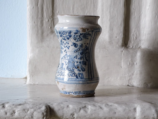 Italian antique albarello jar from the 18th century displayed on a country house fireplace