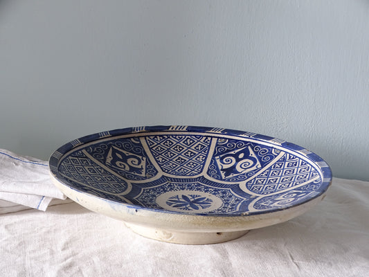 Moroccan antique ceramic charger with blue and white intricate pattern