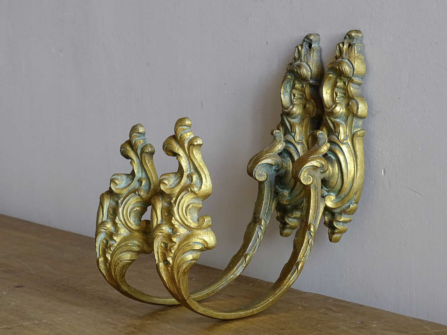 Pair of French antique gilt bronze curtain hooks