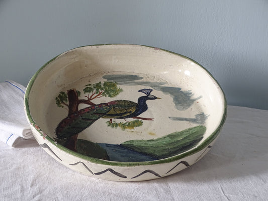 French antique ceramic bowl with peacock decoration, pictured with antique linen