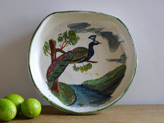 French antique glazed terracotta bowl, with hand-painted green highlights and a peacock motif to the centre. The pottery bowl is flat to the top, it is a decorative bowl for the coffee table or as wall decor.