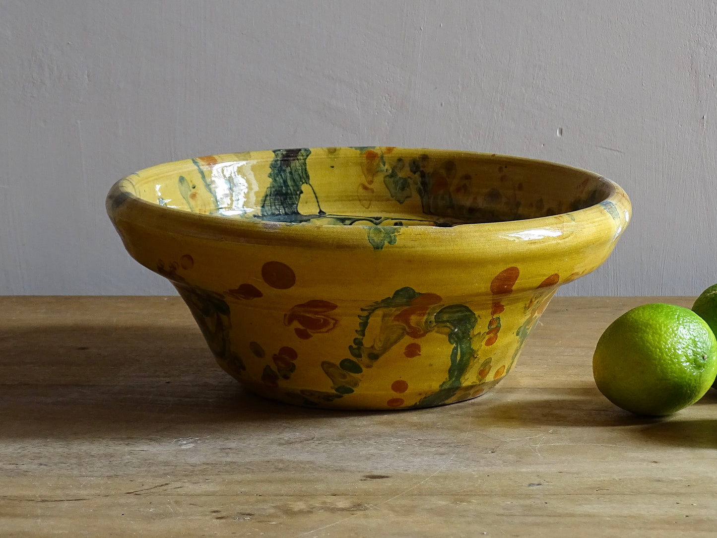 French antique jaspe pottery bowl in yellow ochre and marbled with oranges, greens and blues. Savoie pottery terracotta bowl.  Antique French pottery or antique slipware pottery.