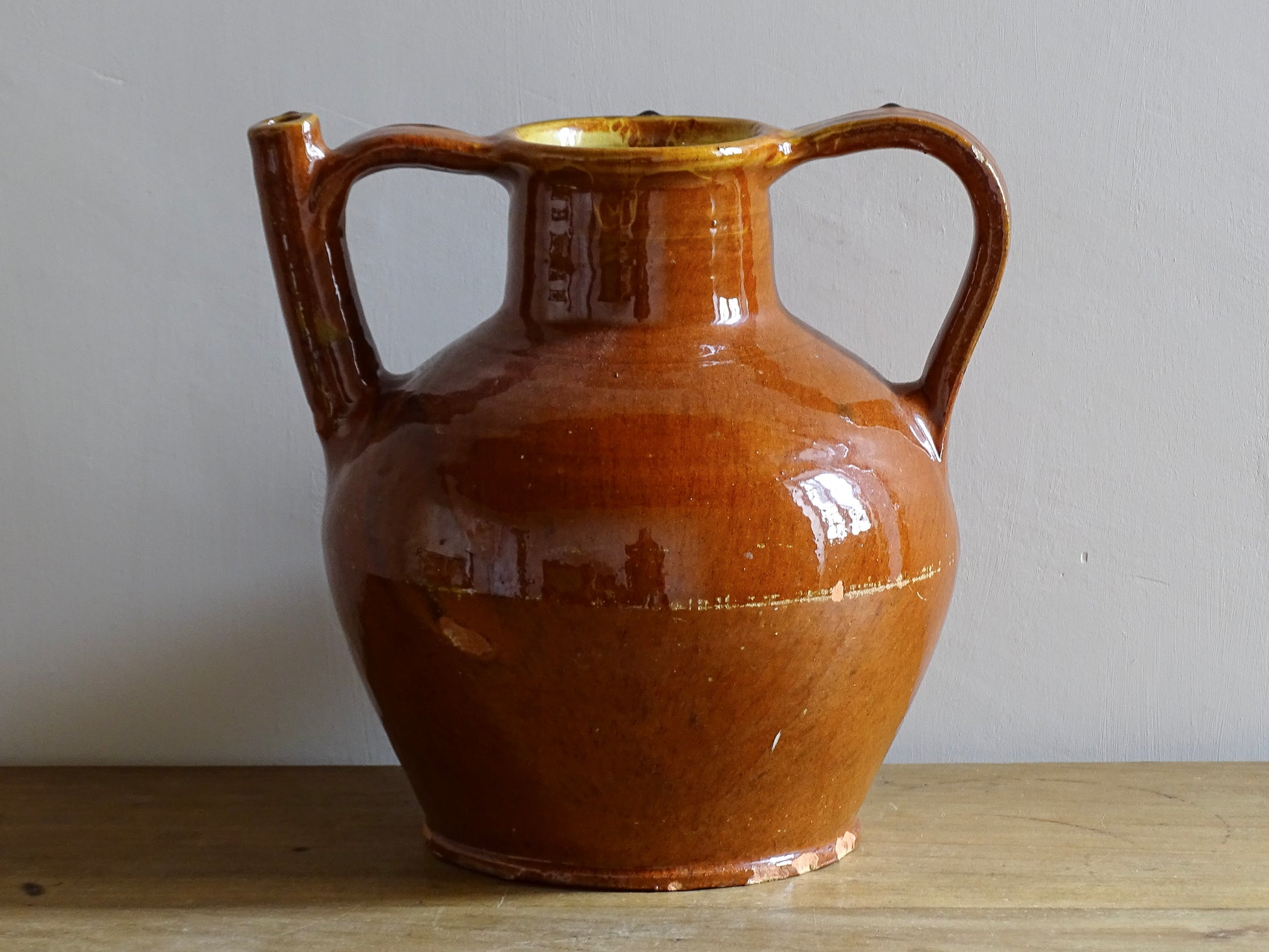 French antique glazed terracotta pottery orjol jug or pitcher with deep orange colour glaze